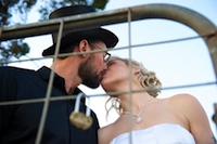 newlyweds attach a love heart shaped padlock to the gate at margaret river heartland