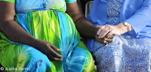 grandmothers holding hands by wedding celebrant