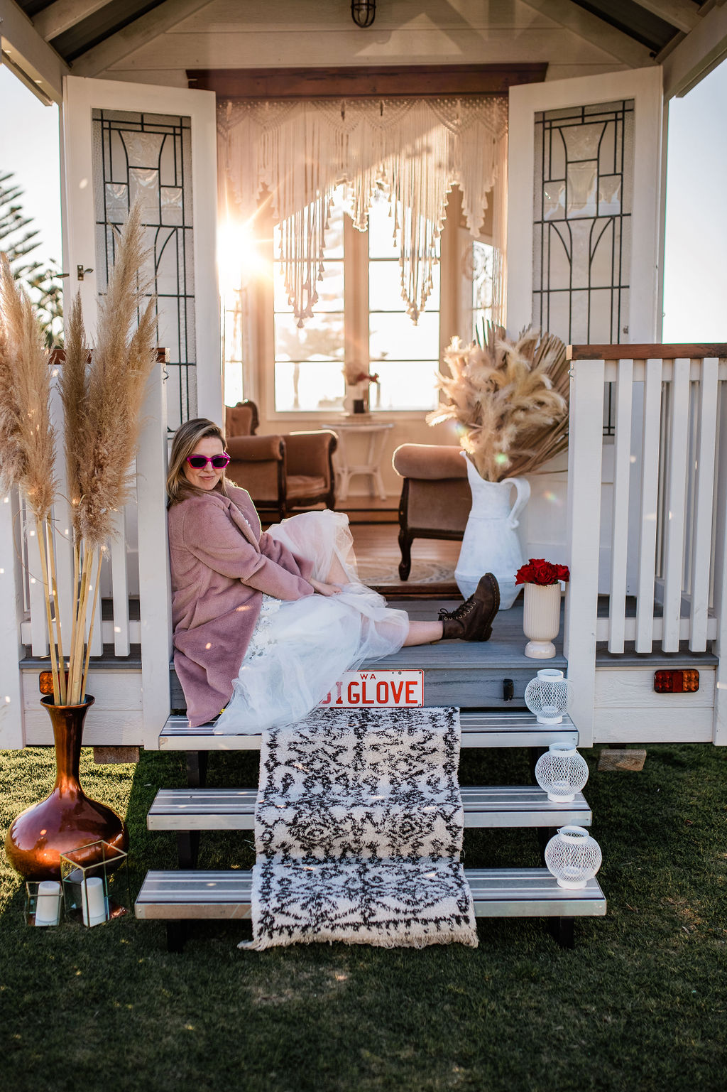 Hipster bride sitting on the steps to Big Love the tiny chapel on wheels in Busselton